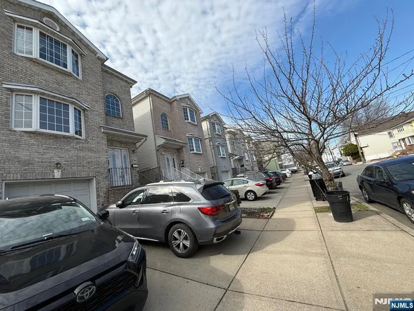 a view of a car parked in front of a brick house
