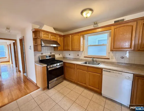 a kitchen with stainless steel appliances granite countertop a sink and cabinets