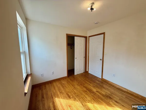 a view of an empty room with glass door