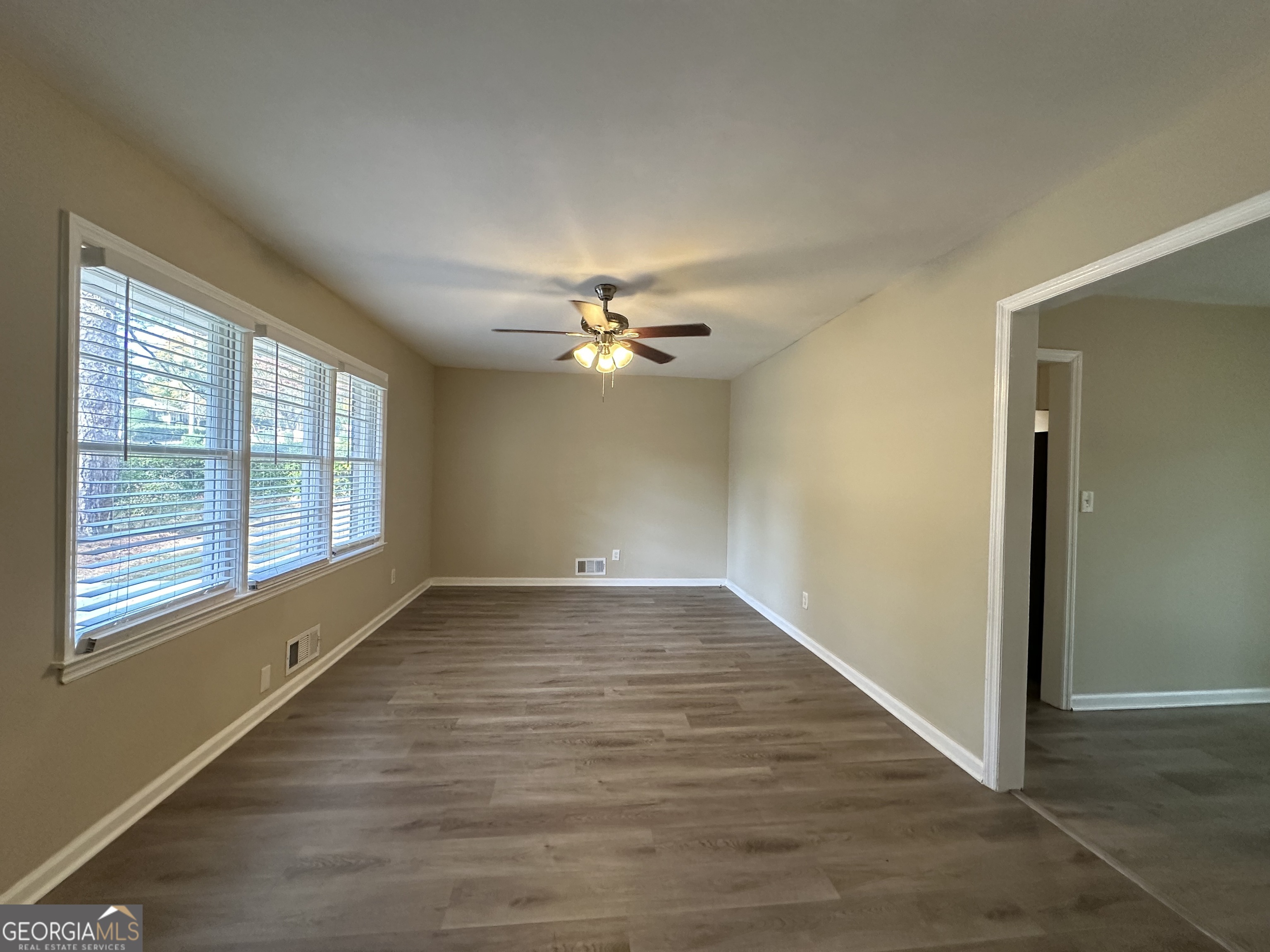 1581 Hollyhock Terrace Decatur, GA 30032 - Photo 4 of 12 a view of an empty room with wooden floor and a window