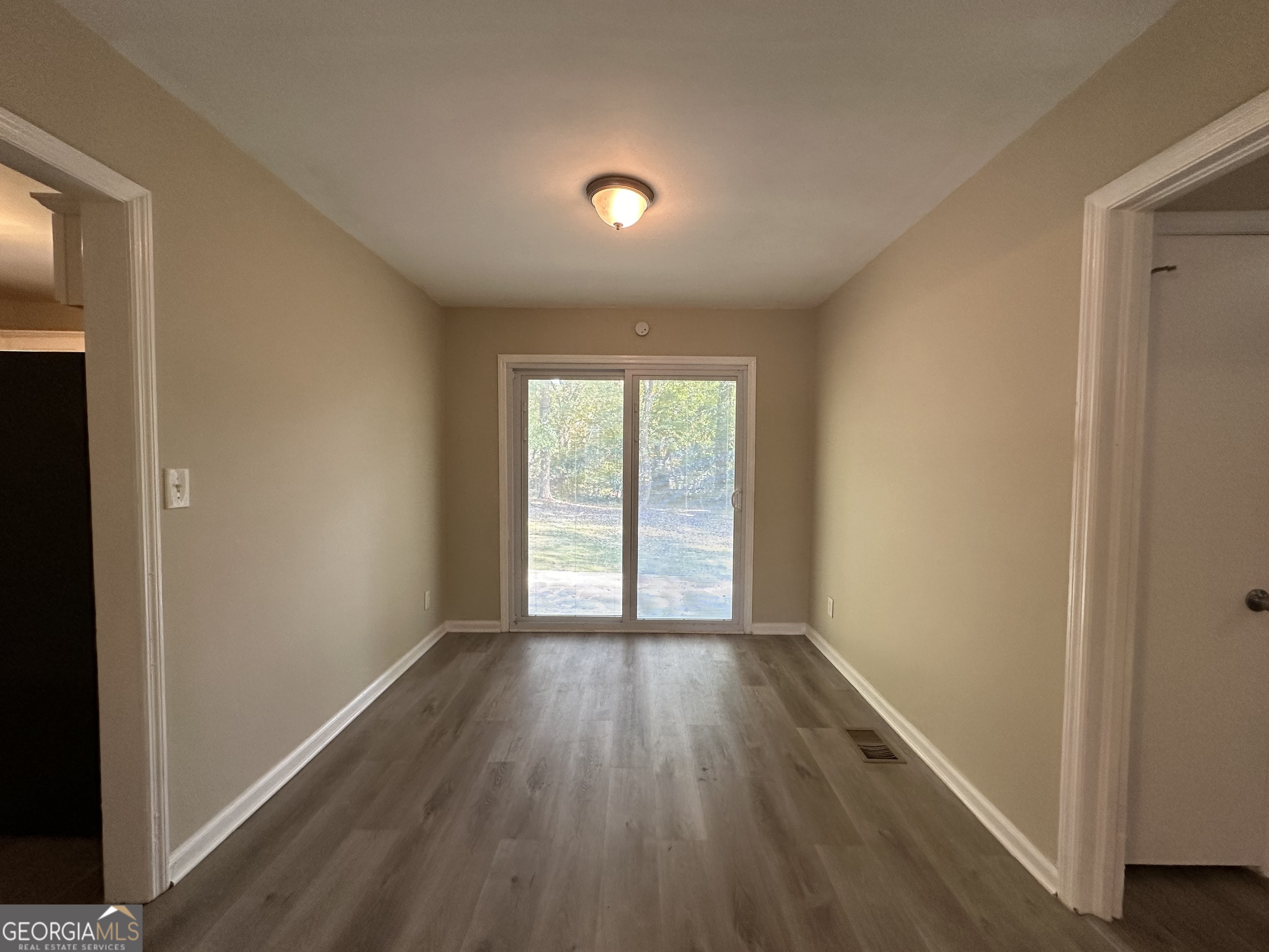 1581 Hollyhock Terrace Decatur, GA 30032 - Photo 5 of 12 a view of an empty room with wooden floor and a window
