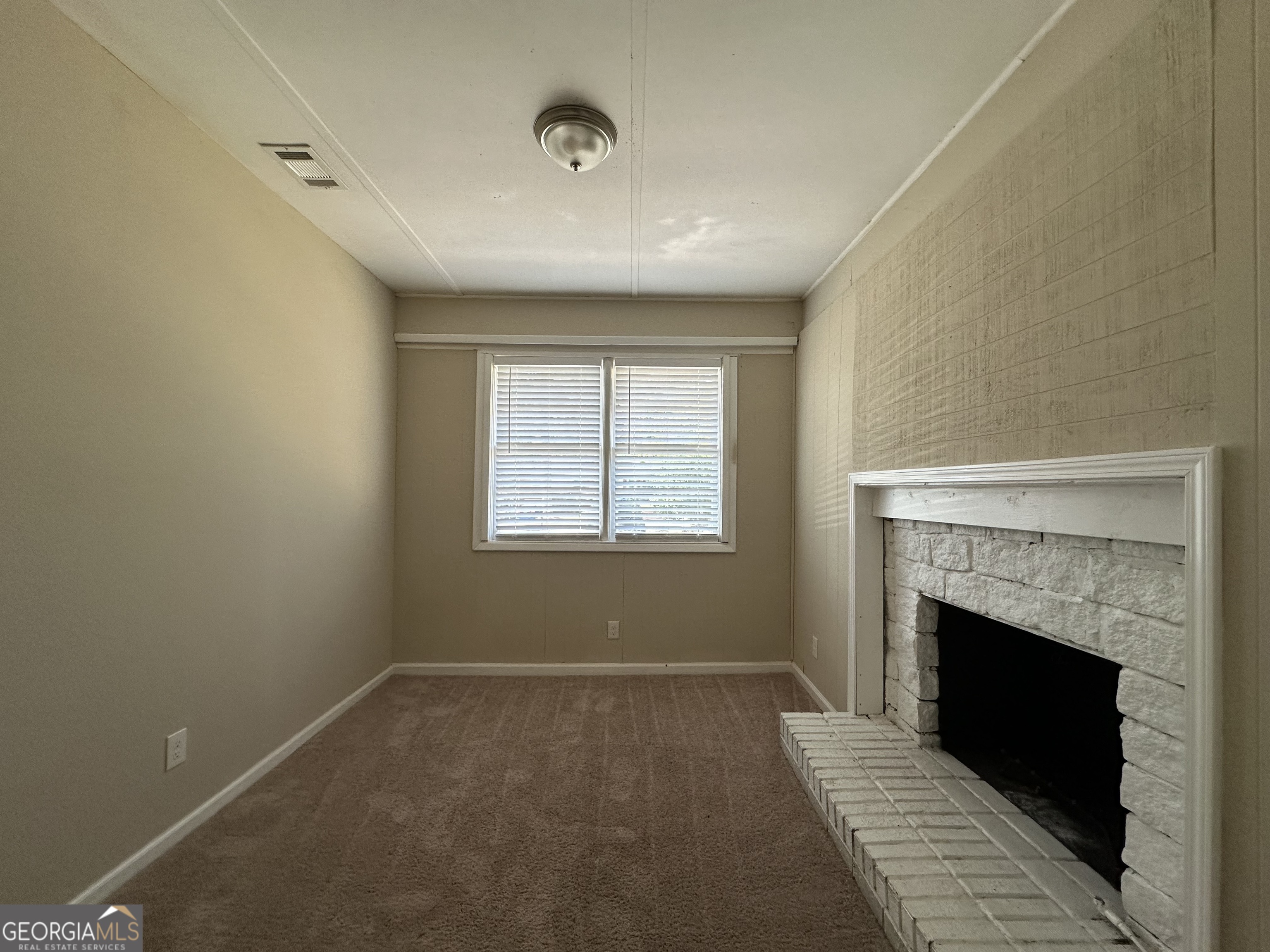 1581 Hollyhock Terrace Decatur, GA 30032 - Photo 7 of 12 a view of a livingroom with a fireplace and window