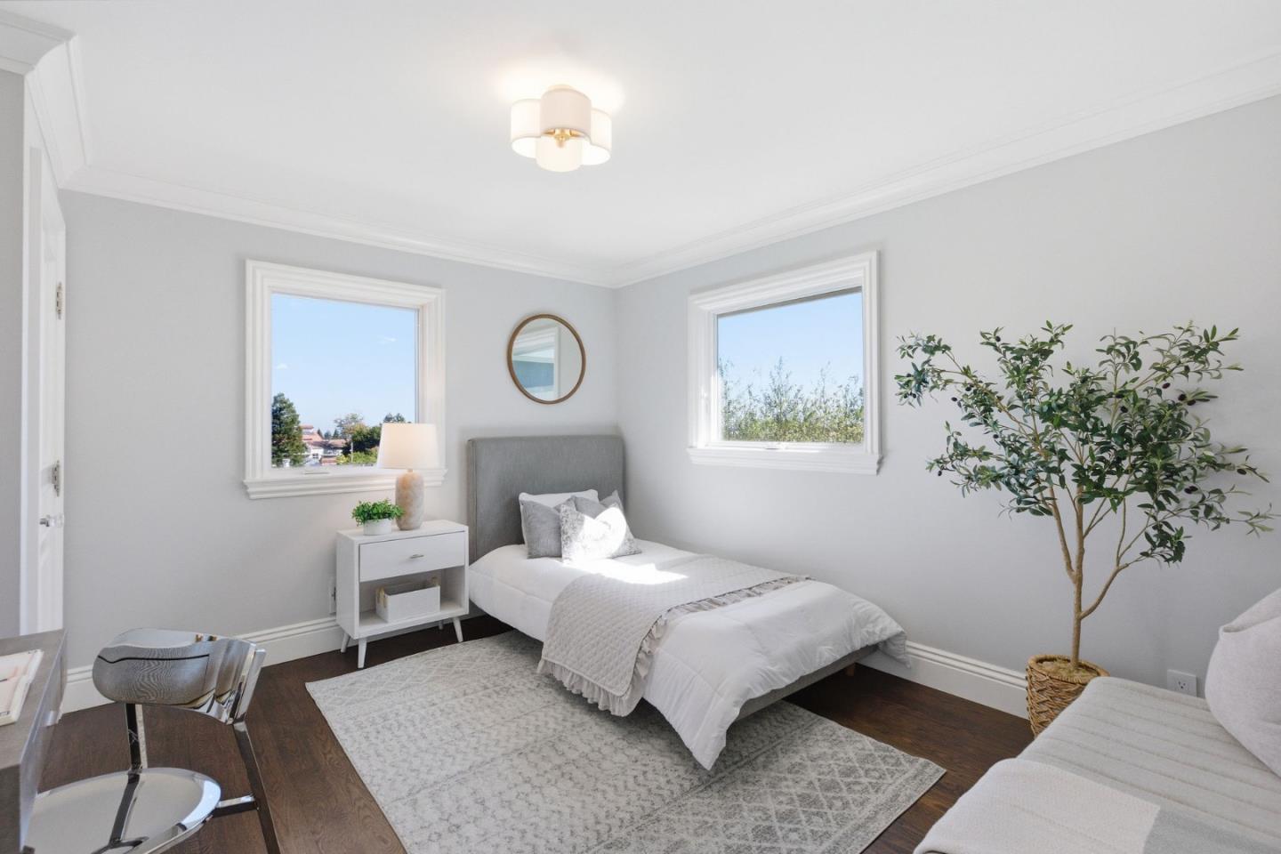 638 Oregon Avenue San Mateo, CA 94402 - Photo 21 of 34 a bedroom with a bed lamp and a potted plant
