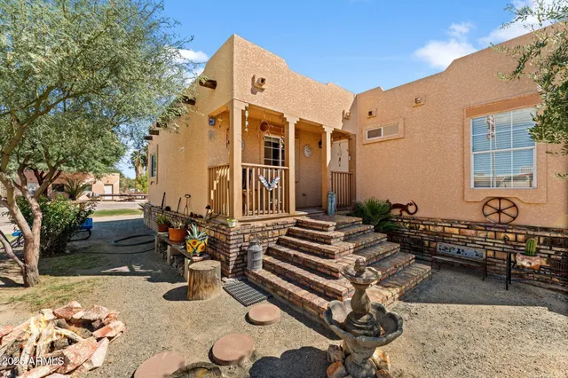 a front view of a house with outdoor seating
