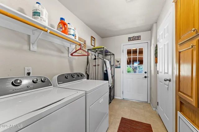 a view of storage and utility room with washer and dryer