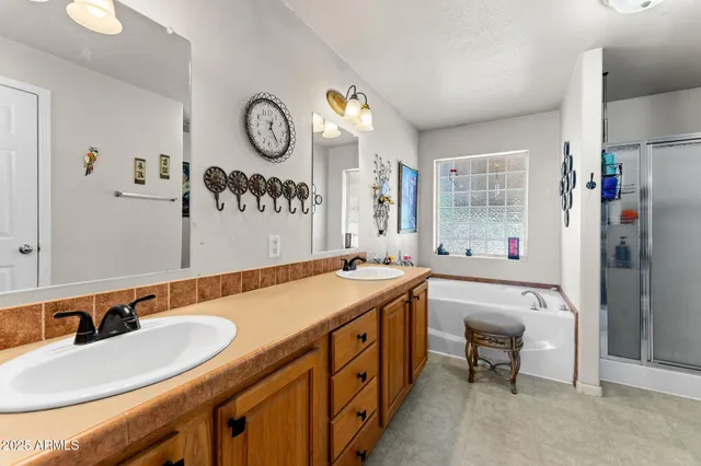 a spacious bathroom with a granite countertop sink and a mirror