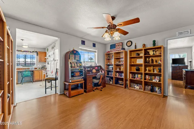 a view of a livingroom with furniture and a bookshelf