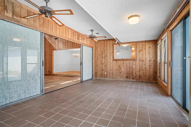 a view of a hallway with wooden shelves