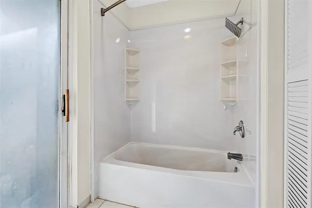 a bathroom with a bathtub and a shower