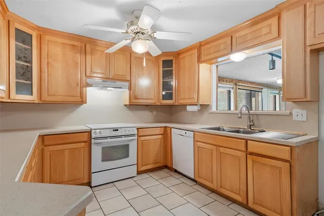 a kitchen with stainless steel appliances granite countertop a sink and dishwasher a stove top oven with wooden floor