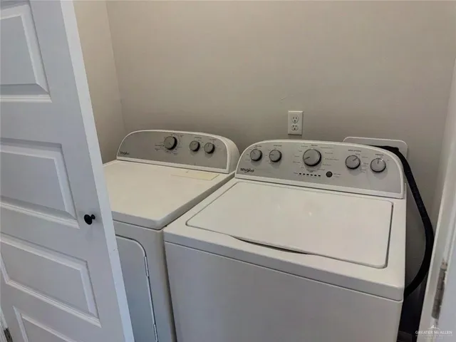 an empty room with wooden floor cabinet and windows