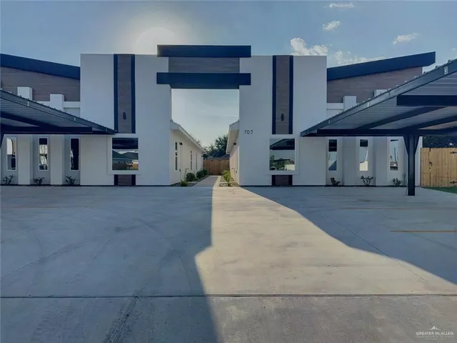 a view of a living room with kitchen