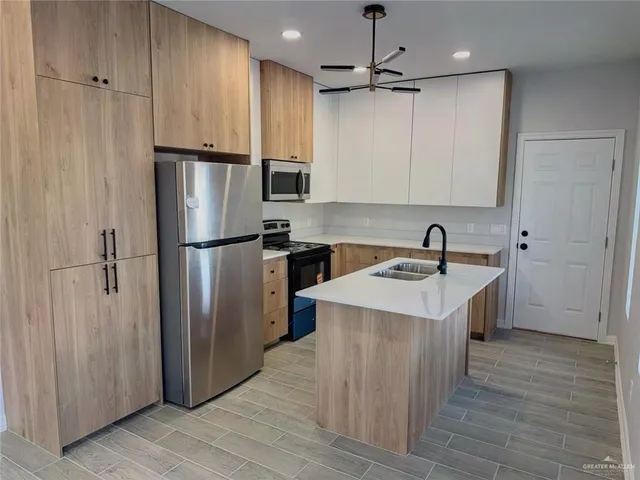a kitchen with a sink and cabinets