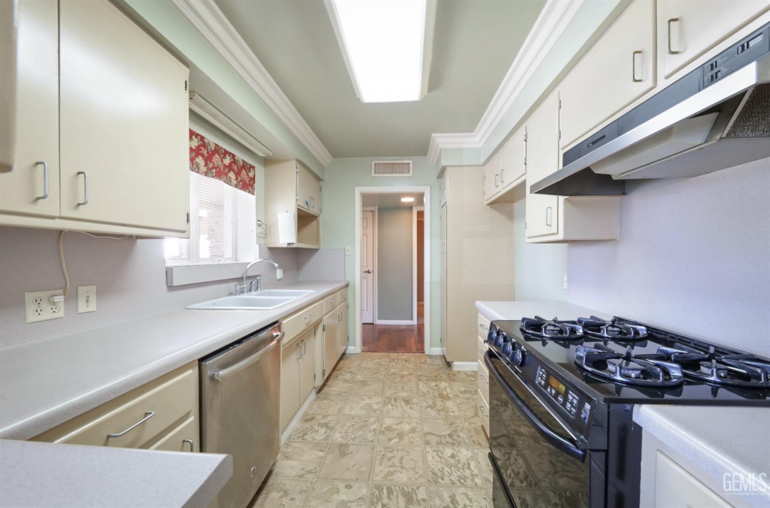 Undisclosed Address Bakersfield, CA 93305 - Photo 11 of 33 a kitchen with a stove and a sink