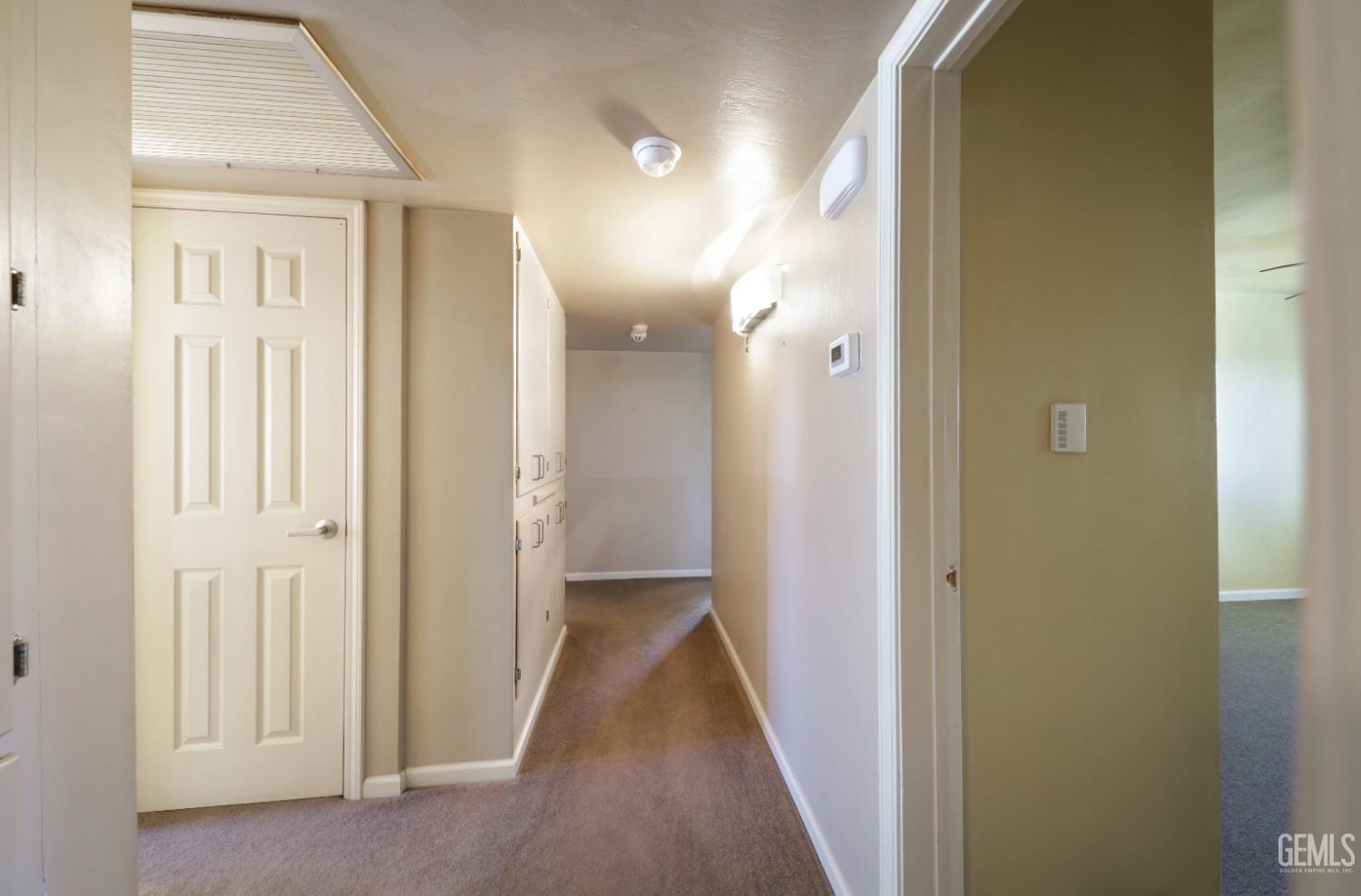 Undisclosed Address Bakersfield, CA 93305 - Photo 14 of 33 a view of a hallway with wooden floor