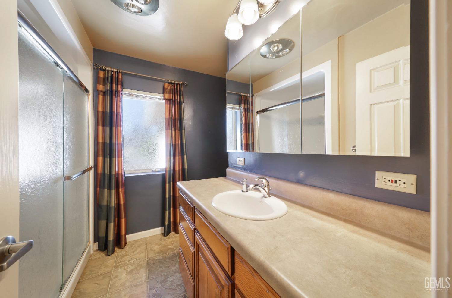 Undisclosed Address Bakersfield, CA 93305 - Photo 16 of 33 a bathroom with a sink and a mirror