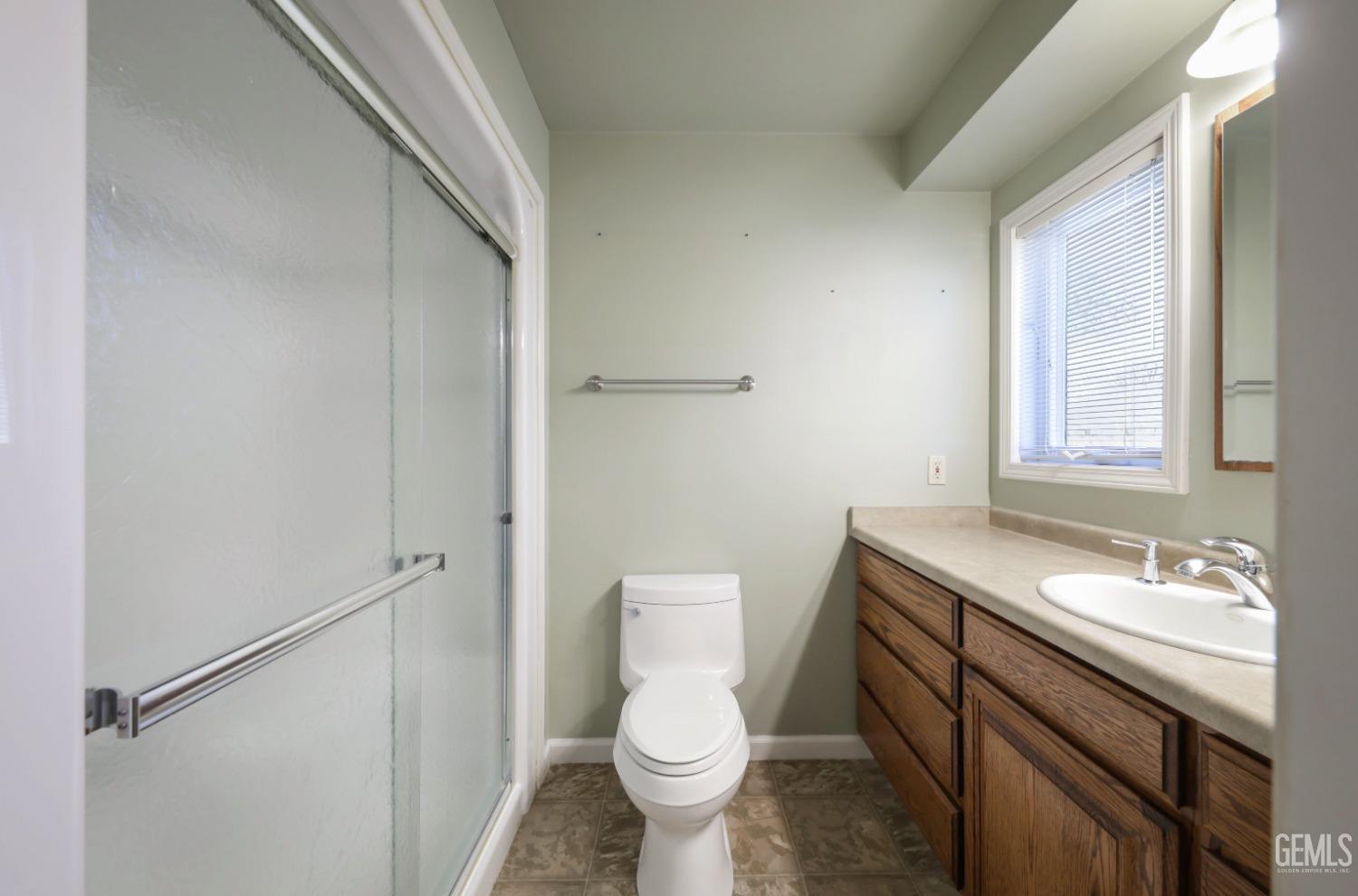 Undisclosed Address Bakersfield, CA 93305 - Photo 19 of 33 a bathroom with a granite countertop toilet sink and mirror