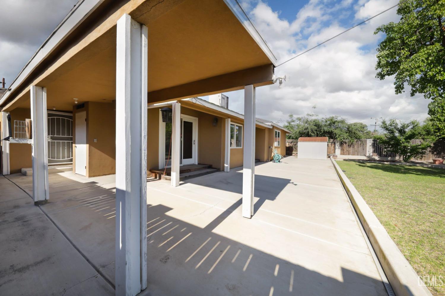 Undisclosed Address Bakersfield, CA 93305 - Photo 23 of 33 a view of a patio with a table chairs and wooden floor