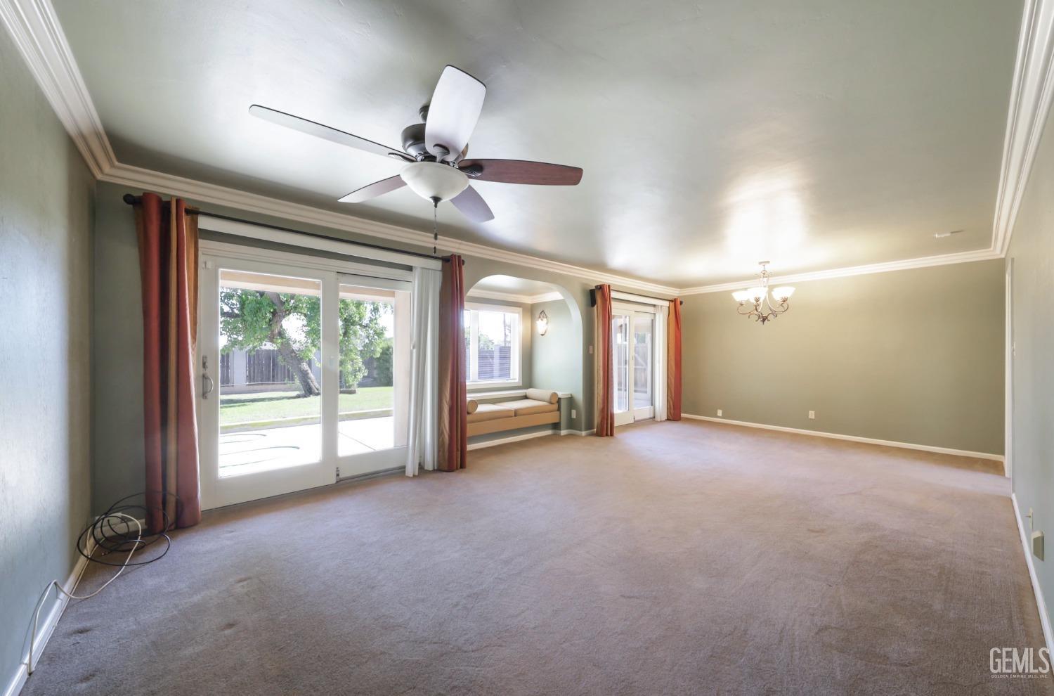 Undisclosed Address Bakersfield, CA 93305 - Photo 7 of 33 an empty room with windows and fan