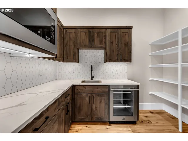 a kitchen with stainless steel appliances a stove and cabinets
