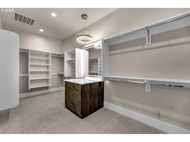 a view of walk in closet with empty racks