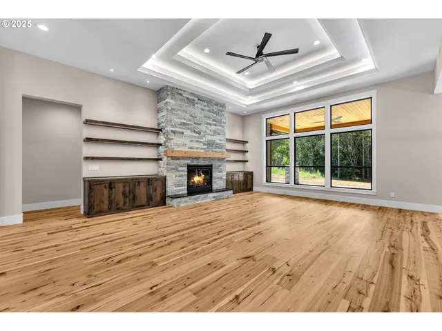 a view of an empty room with a fireplace and a window