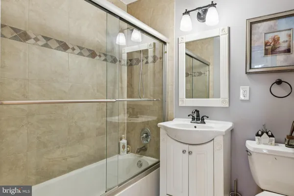 a bathroom with a sink mirror toilet and bathtub
