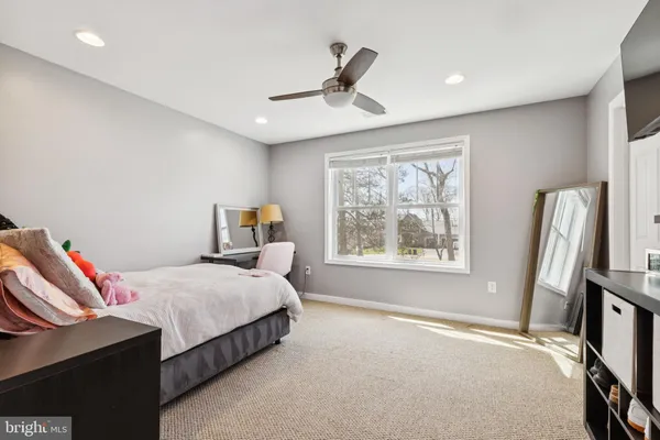 a bedroom with a bed and a large window