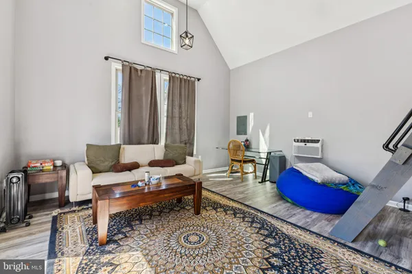 a living room with furniture and a rug