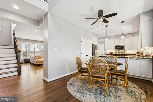 a dining room with furniture and wooden floor