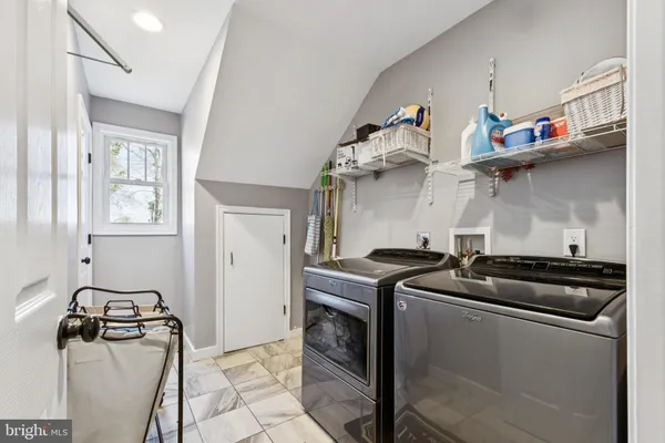a utility room with closet a stove and wooden floor