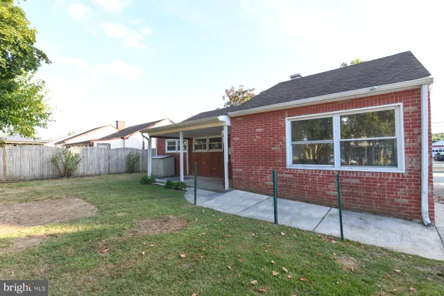 a view of a house with a yard and a garden