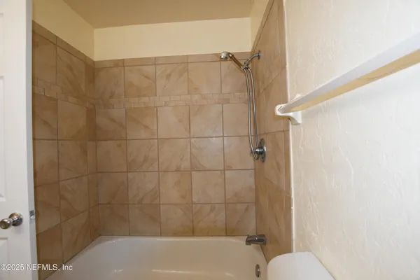 a bathroom with a shower and a toilet