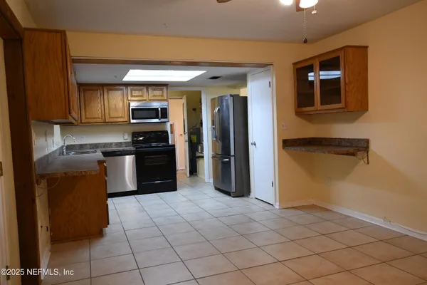 a view of kitchen with granite countertop cabinets and outdoor space