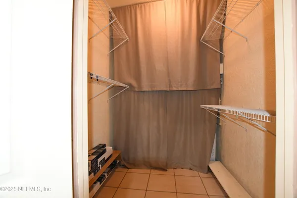 a bedroom with a bed and a flat screen television