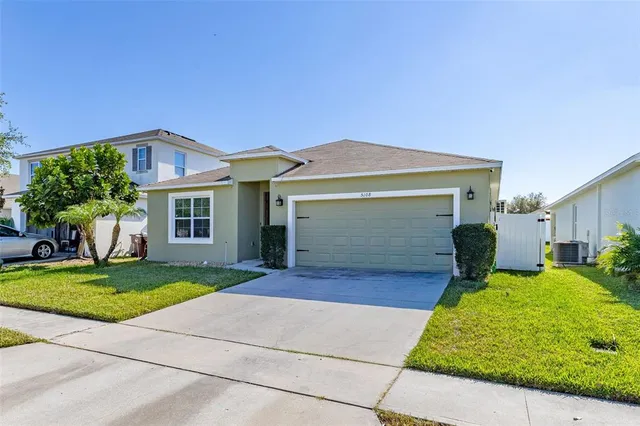 a front view of house with yard and green space