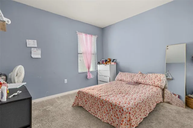 a bedroom with a bed and chair