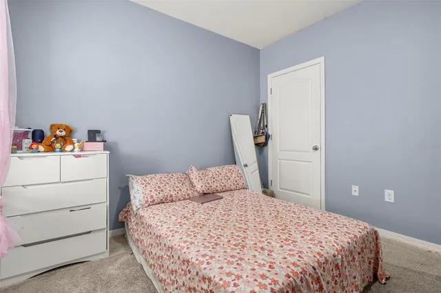 a bedroom with a bed and cabinets