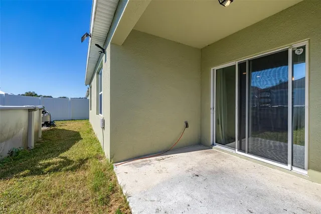 a view of a house with pool and chairs