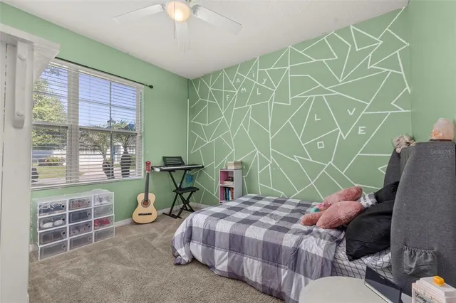 a bedroom with a bed and a window