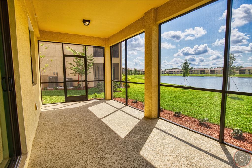 12355 Ghiberti Circle, Unit 101 Venice, FL 34293 - Photo 18 of 41 a view of porch with a floor to ceiling window next to a yard