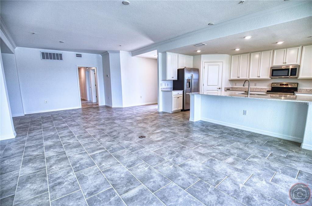 12355 Ghiberti Circle, Unit 101 Venice, FL 34293 - Photo 21 of 41 a view of kitchen with stainless steel appliances granite countertop a refrigerator and a stove top oven