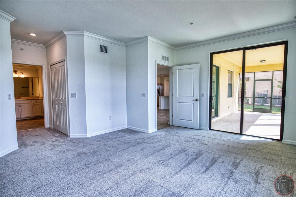 12355 Ghiberti Circle, Unit 101 Venice, FL 34293 - Photo 24 of 41 an empty room with closet and a yard