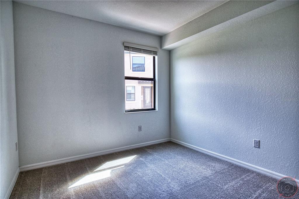 12355 Ghiberti Circle, Unit 101 Venice, FL 34293 - Photo 28 of 41 an empty room with windows