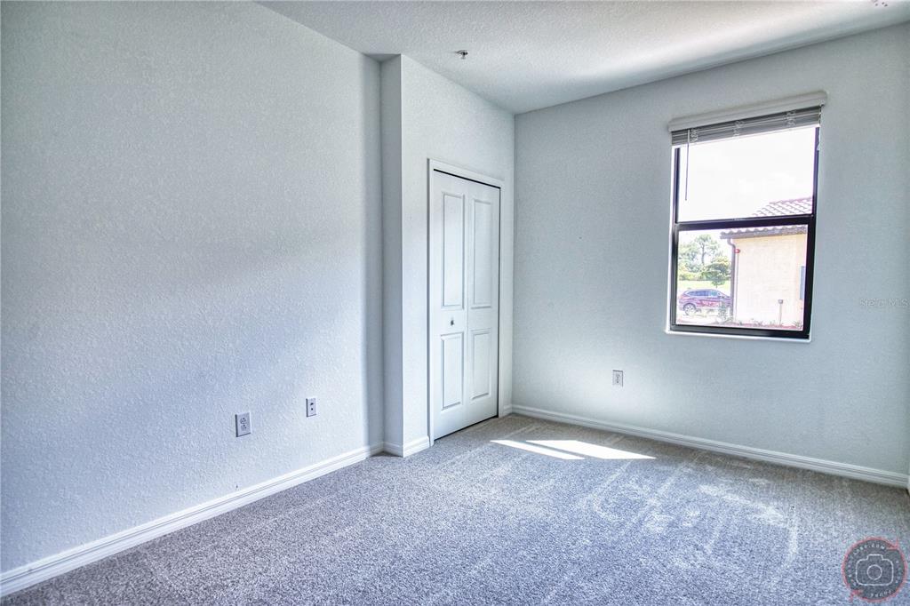 12355 Ghiberti Circle, Unit 101 Venice, FL 34293 - Photo 31 of 41 an empty room with windows and closet