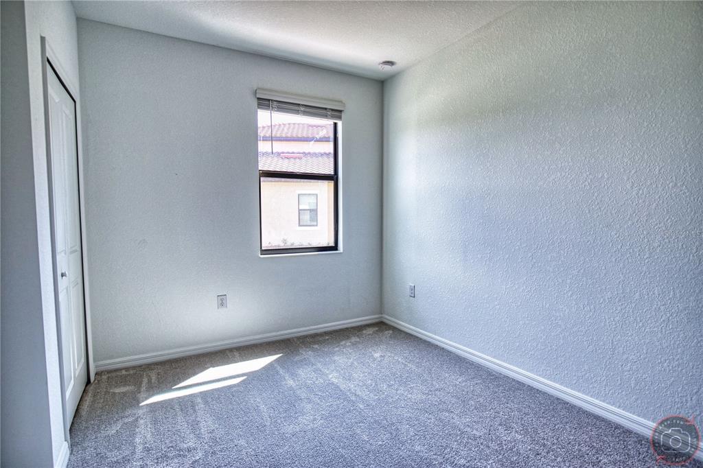 12355 Ghiberti Circle, Unit 101 Venice, FL 34293 - Photo 33 of 41 an empty room with windows