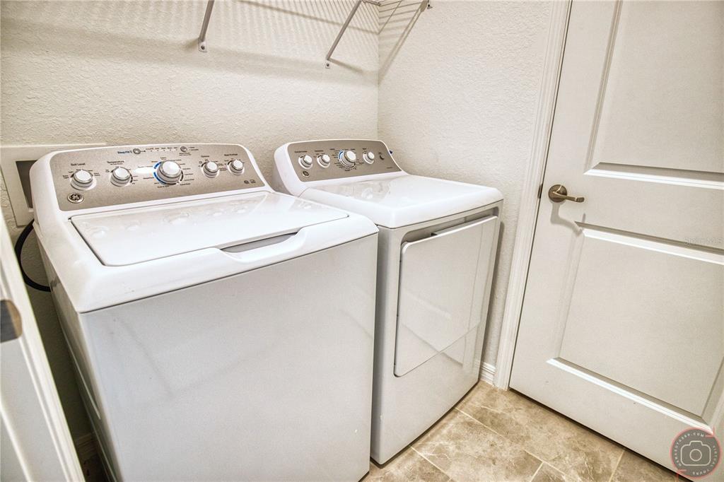 12355 Ghiberti Circle, Unit 101 Venice, FL 34293 - Photo 34 of 41 a utility room with dryer and washer