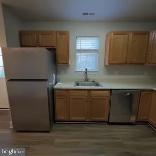 a kitchen with a refrigerator and a sink