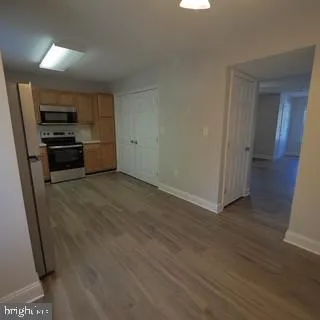a kitchen with stainless steel appliances a refrigerator and a stove top oven