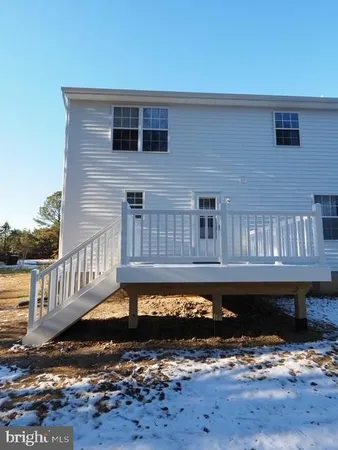 a view of a deck with a table chairs